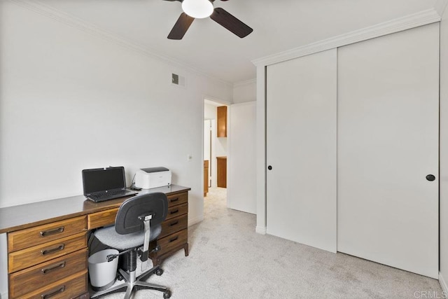 office space with crown molding, light colored carpet, and ceiling fan