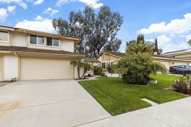 view of front of home with a garage, driveway, and a front lawn