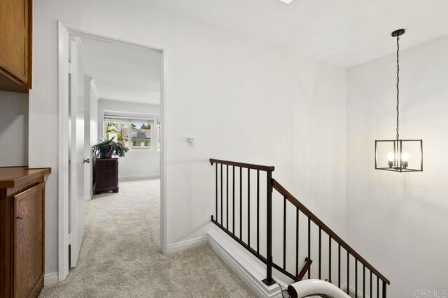 9501 High Park Ln, San Diego, CA 92129 - hallway featuring carpet floors, an upstairs landing, and a chandelier