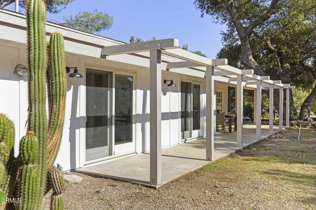 back of house with a patio area and a pergola