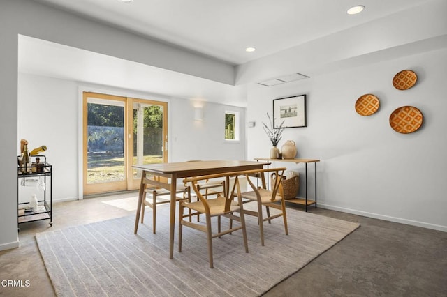 dining room with concrete floors, baseboards, and recessed lighting
