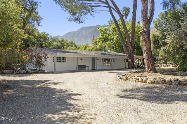 view of front facade with driveway and a mountain view