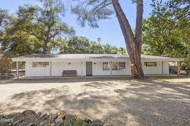 ranch-style home featuring driveway and board and batten siding