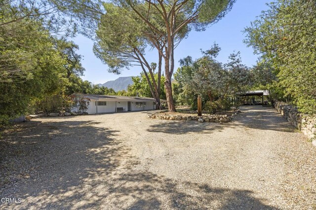 view of front facade featuring driveway and a mountain view
