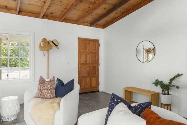 living room with concrete floors and wood ceiling