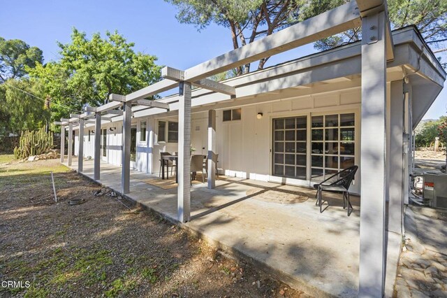 rear view of house with a patio and board and batten siding