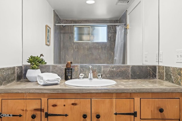 bathroom featuring vanity and a shower with shower curtain