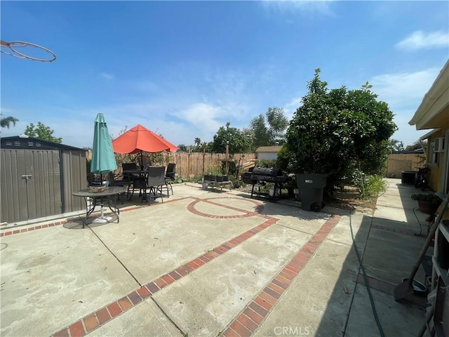 view of patio featuring a fenced backyard, outdoor dining space, and a grill