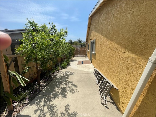 view of home's exterior featuring stucco siding, a fenced backyard, and a patio area