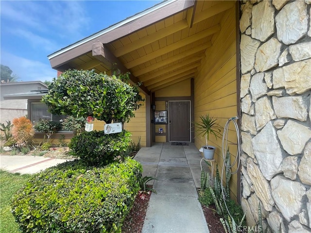 property entrance with stone siding