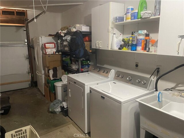 laundry area featuring washing machine and dryer and cabinet space