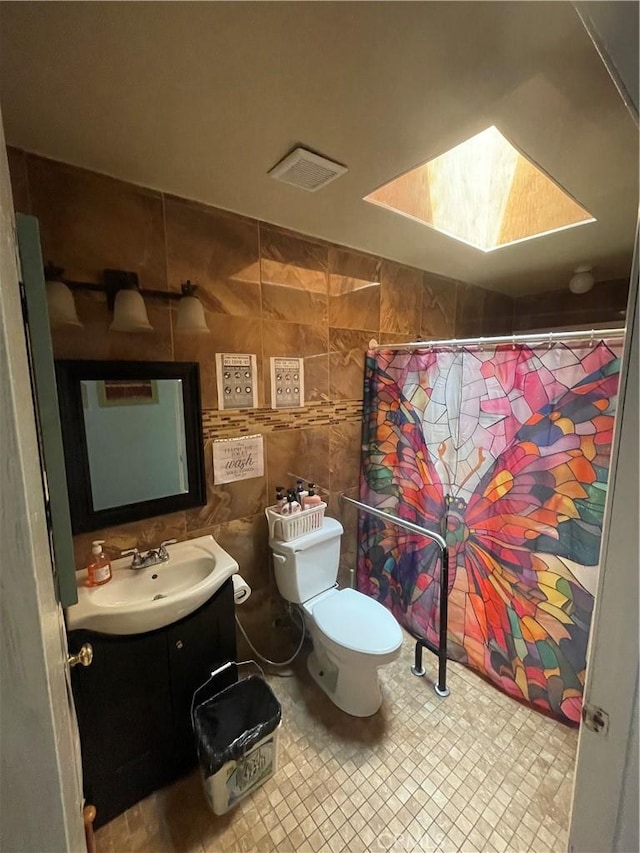 full bathroom with vanity, tile walls, toilet, and a shower with curtain