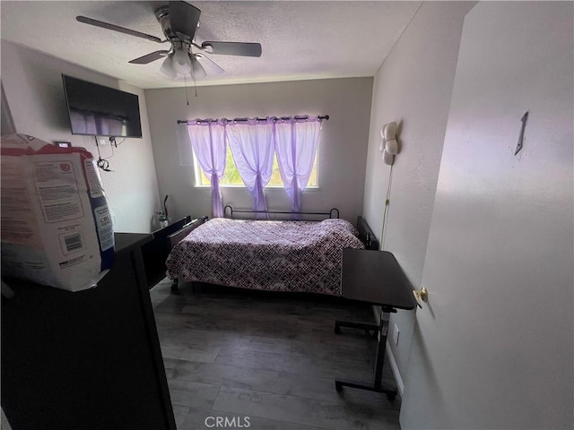 bedroom with a ceiling fan and wood finished floors
