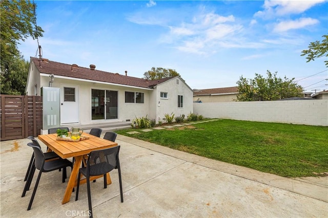 back of house with stucco siding, a patio area, and outdoor dining space
