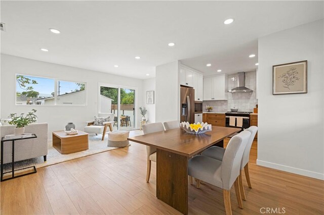 dining area with light wood finished floors, recessed lighting, and baseboards
