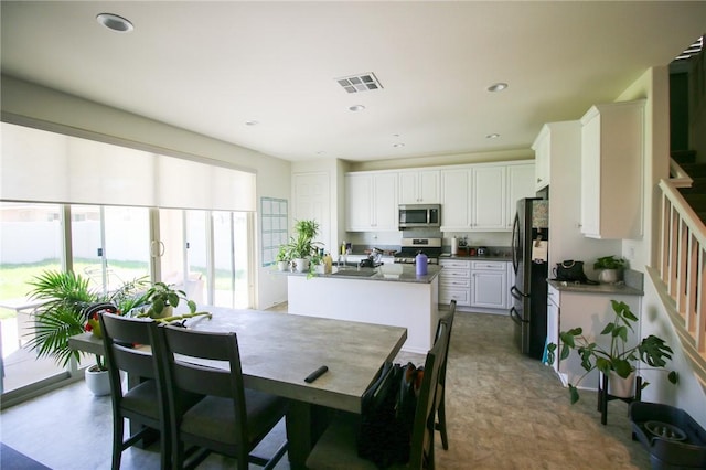 dining room with stairway and recessed lighting