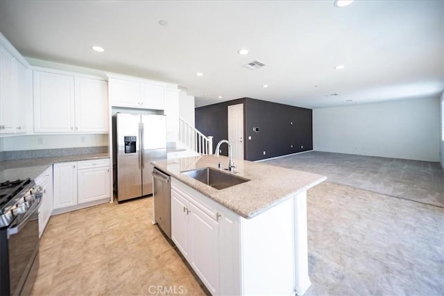 3409 Spring Wheat St, Perris, CA 92570 - kitchen with a sink, appliances with stainless steel finishes, white cabinetry, and recessed lighting