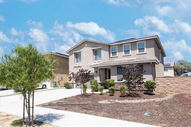 3409 Spring Wheat St, Perris, CA 92570 - traditional-style house featuring stucco siding, roof mounted solar panels, and driveway