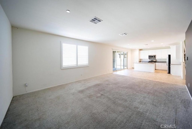 3409 Spring Wheat St, Perris, CA 92570 - unfurnished living room with light carpet, recessed lighting, and baseboards