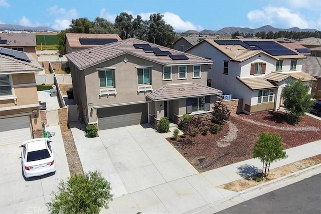 3409 Spring Wheat St, Perris, CA 92570 - view of front of house with a residential view, an attached garage, driveway, stucco siding, and solar panels