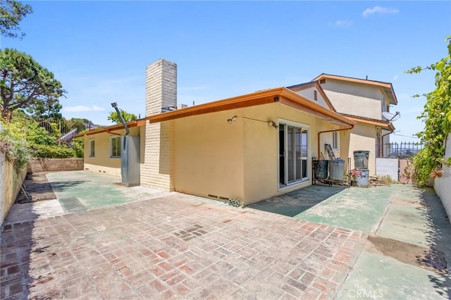 5134 Veronica St, Los Angeles, CA 90008 - rear view of property featuring a chimney, stucco siding, and a fenced backyard