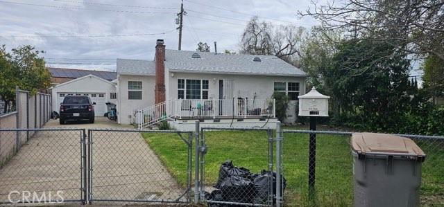 1409 Dobros Dr, West Sacramento, CA 95605 - ranch-style home featuring concrete driveway, a gate, a chimney, a detached garage, and stucco siding