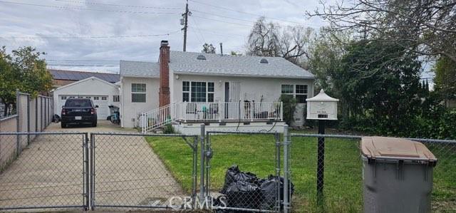 1409 Dobros Dr, West Sacramento, CA 95605 - single story home featuring driveway, a gate, a chimney, a detached garage, and stucco siding