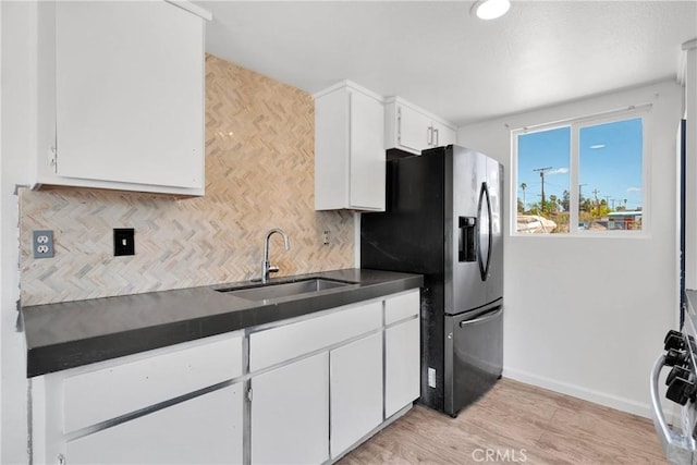 71854 El Paseo Dr Unit 29, Palms, CA 92277 - kitchen with a sink, dark countertops, stainless steel fridge with ice dispenser, backsplash, and baseboards