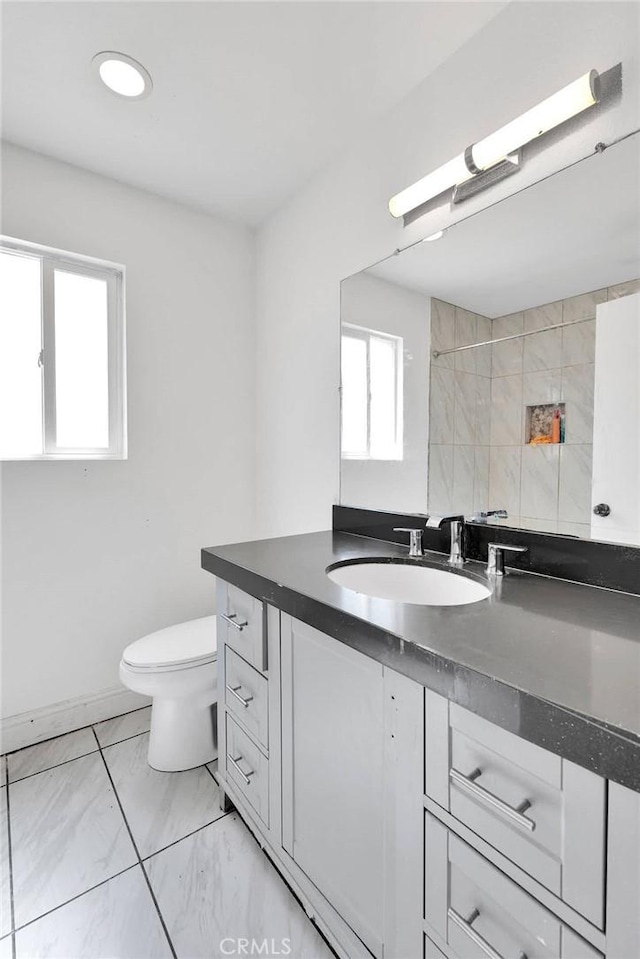 71854 El Paseo Dr Unit 29, Palms, CA 92277 - bathroom featuring toilet, vanity, and marble look tiles