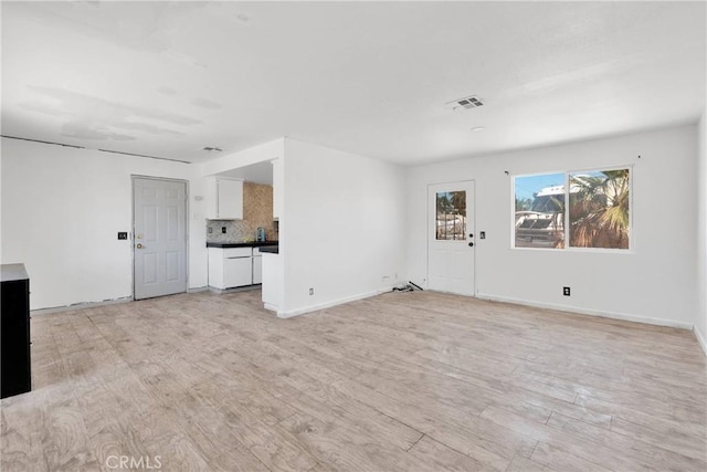 71854 El Paseo Dr Unit 29, Palms, CA 92277 - unfurnished living room with light wood-style flooring and baseboards