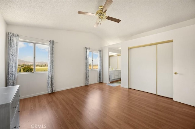 27559 Avenida Interno, Menifee, CA 92585 - unfurnished bedroom featuring wood finished floors, vaulted ceiling, a textured ceiling, a closet, and ensuite bathroom