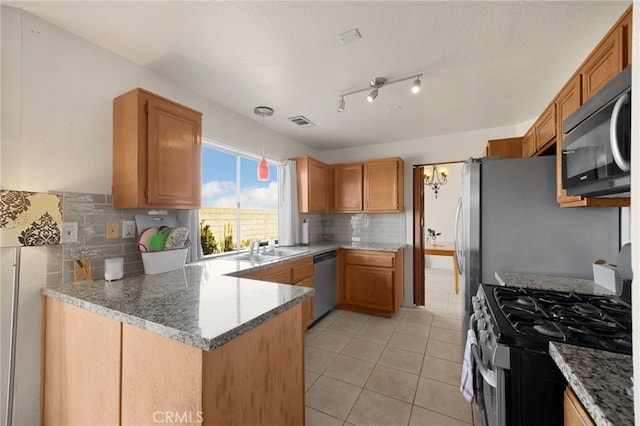 27559 Avenida Interno, Menifee, CA 92585 - kitchen with appliances with stainless steel finishes, a peninsula, tasteful backsplash, light tile patterned flooring, and a sink