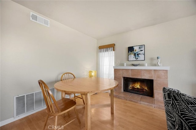 27559 Avenida Interno, Menifee, CA 92585 - dining room featuring light wood finished floors, a tiled fireplace, and baseboards