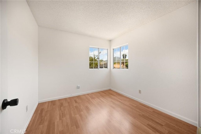27559 Avenida Interno, Menifee, CA 92585 - empty room with light wood-style flooring, a textured ceiling, and baseboards