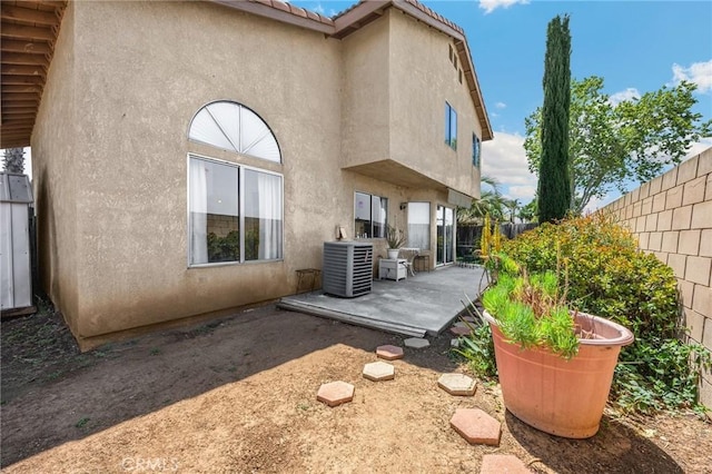 27559 Avenida Interno, Menifee, CA 92585 - back of property featuring central AC, stucco siding, a patio area, and a fenced backyard