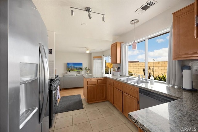 27559 Avenida Interno, Menifee, CA 92585 - kitchen featuring stainless steel appliances, a sink, open floor plan, a peninsula, and light tile patterned floors