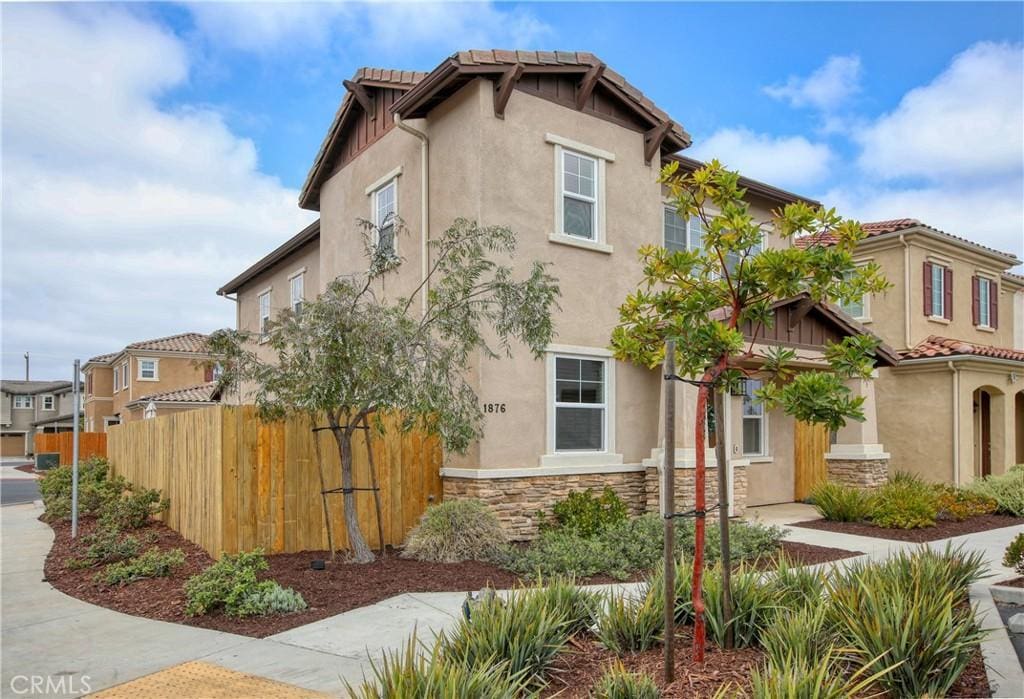 1876 Sterling Pl, Santa Maria, CA 93458 - view of front of property featuring fence, stucco siding, stone siding, and a tile roof