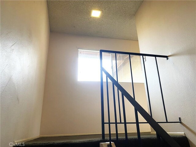 1740 Silver Maple Dr, La Habra, CA 90631 - stairway with a textured ceiling and baseboards