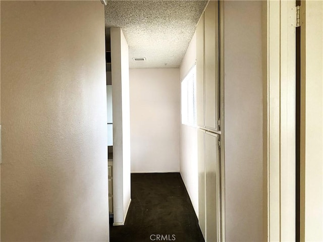 1740 Silver Maple Dr, La Habra, CA 90631 - hallway with dark carpet and a textured ceiling