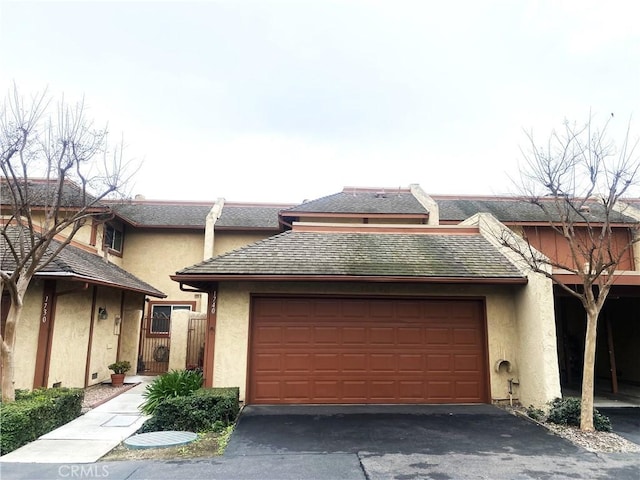 1740 Silver Maple Dr, La Habra, CA 90631 - view of property featuring an attached garage, asphalt driveway, and stucco siding