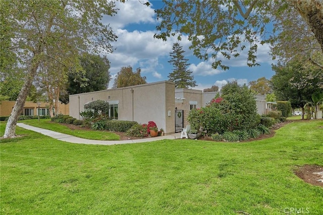 3004 Via Buena Vis Unit C, Laguna Woods, CA 92637 - view of home's exterior with a lawn and stucco siding