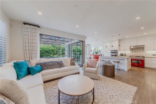 living room featuring light wood finished floors and recessed lighting