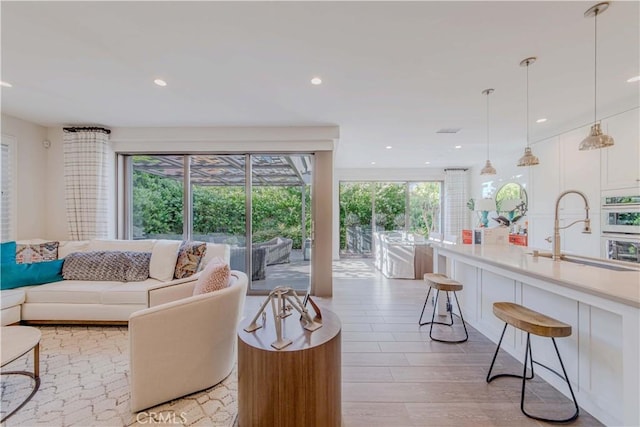 living room with recessed lighting and light wood-style flooring