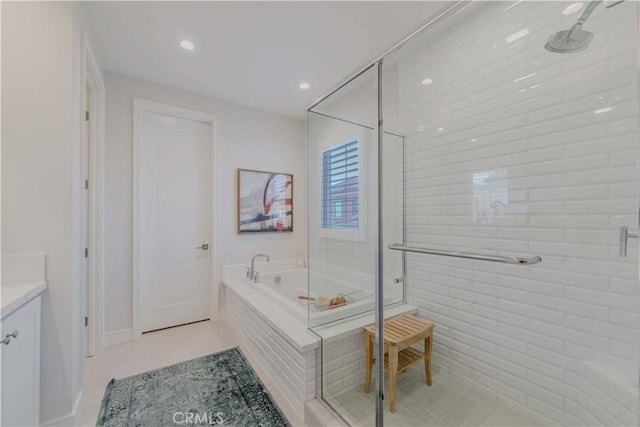 bathroom with a stall shower, a garden tub, vanity, recessed lighting, and tile patterned flooring
