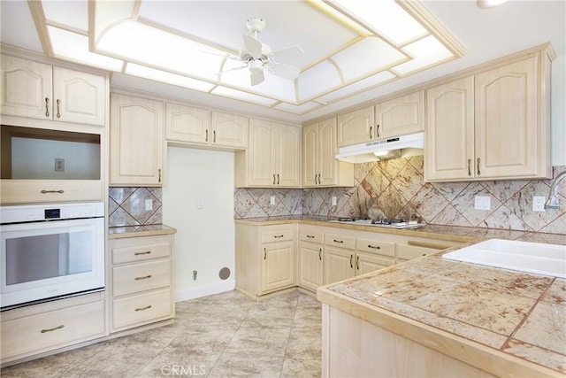 611 Colonial Cir, Fullerton, CA 92835 - kitchen with white appliances, under cabinet range hood, a sink, ceiling fan, and backsplash