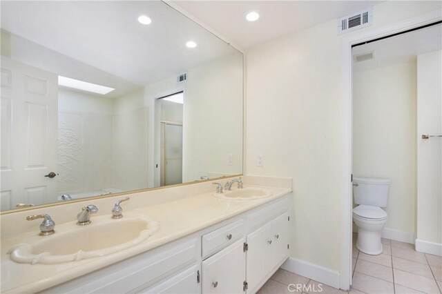 611 Colonial Cir, Fullerton, CA 92835 - bathroom with tile patterned flooring, toilet, baseboards, double vanity, and a shower stall