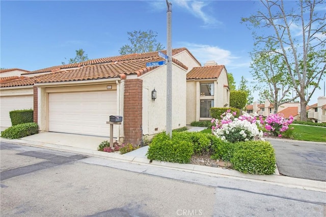 611 Colonial Cir, Fullerton, CA 92835 - view of property exterior with a garage, stucco siding, a tile roof, and driveway