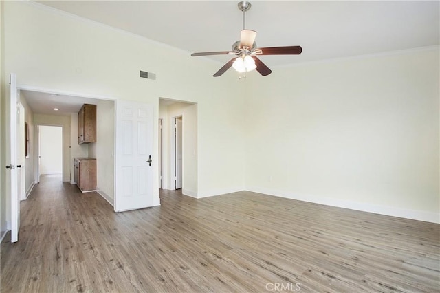 611 Colonial Cir, Fullerton, CA 92835 - unfurnished room featuring light wood finished floors, baseboards, a ceiling fan, and crown molding