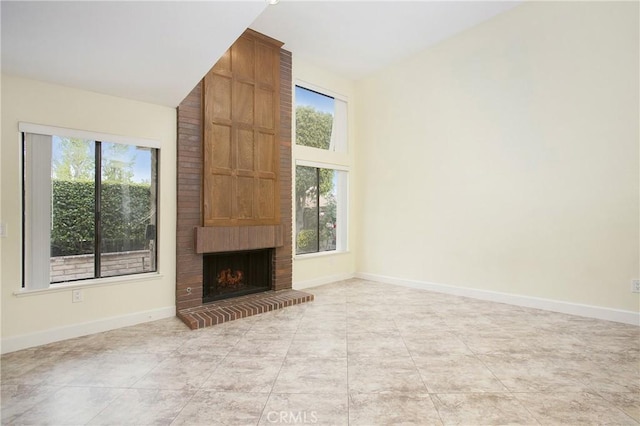 611 Colonial Cir, Fullerton, CA 92835 - unfurnished living room with a fireplace, baseboards, light tile patterned floors, and vaulted ceiling