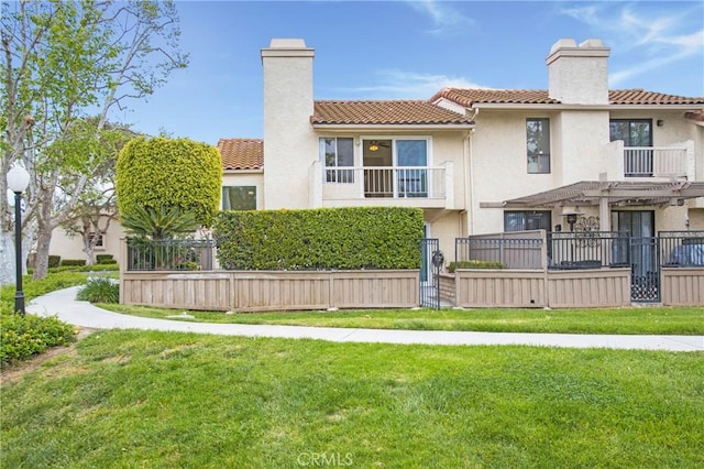 611 Colonial Cir, Fullerton, CA 92835 - back of house featuring a chimney, a tiled roof, a balcony, and stucco siding